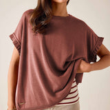 Burnt brick short-sleeve knit sweater with ruffled edges and a relaxed fit.