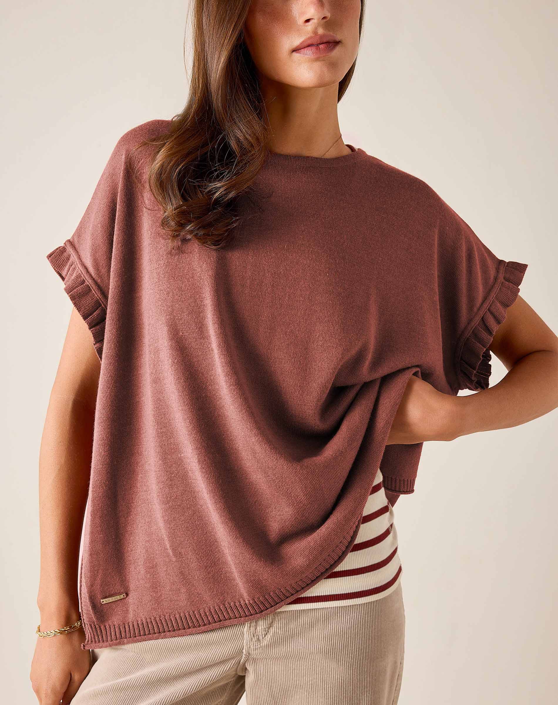 Burnt brick short-sleeve knit sweater with ruffled edges and a relaxed fit.