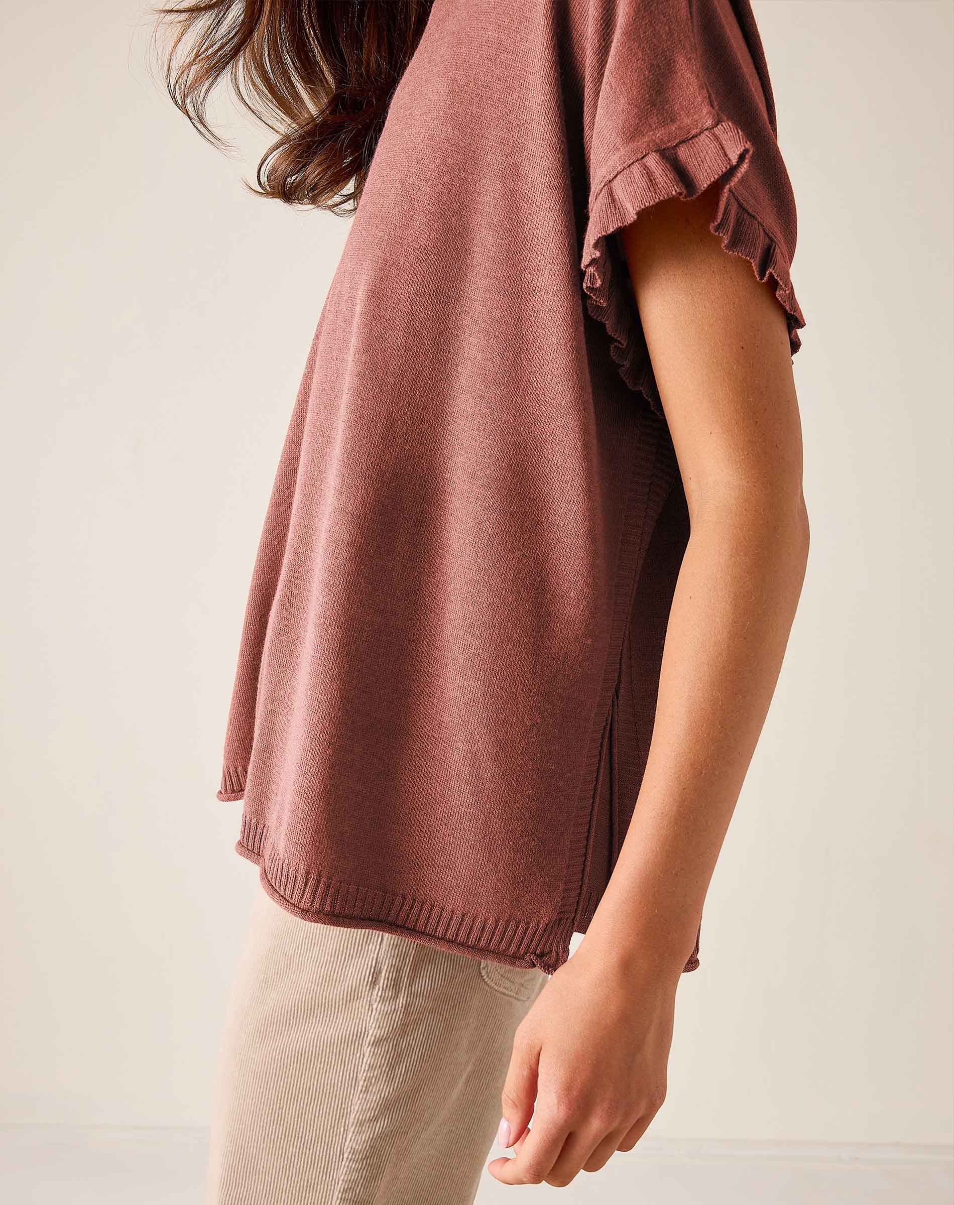 Burnt brick short-sleeve knit sweater with ruffled edges and a relaxed fit.