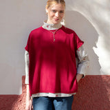 MERSEA women's travel-friendly jester red short-sleeve knit sweater over a white collared shirt with denim jeans.