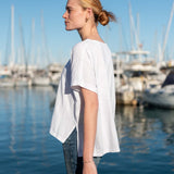 Women's travel-friendly white short-sleeve tee with a relaxed fit and cotton texture.