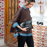 Model wearing a coffee-colored slub tee with denim-trimmed sleeves and black pants.