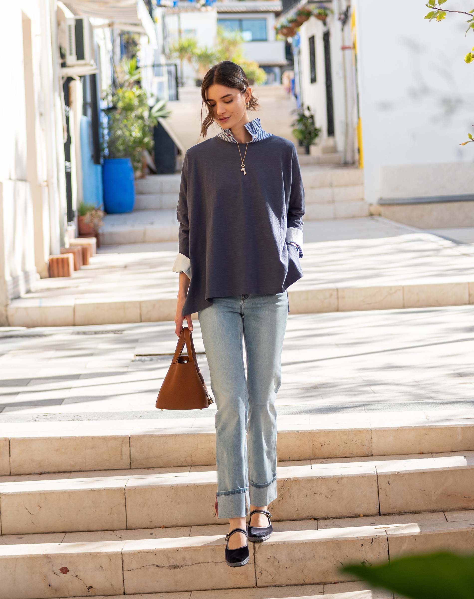 MERSEA women's travel-friendly indigo slub tee with a relaxed fit and long sleeves layered over a striped shirt.