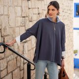 Model in an indigo slub tee with a striped lining and light blue jeans.