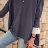 Indigo slub knit tee with a wide neckline and white contrast trim on the sleeve cuff.