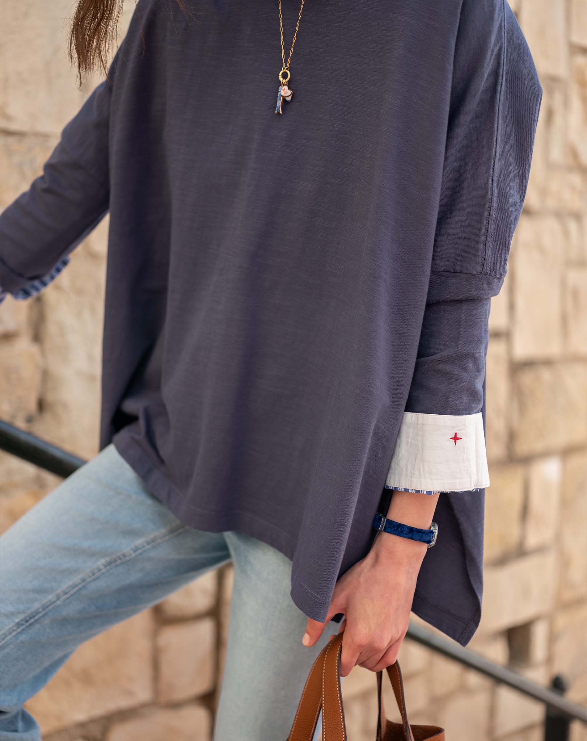 Indigo slub knit tee with a wide neckline and white contrast trim on the sleeve cuff.