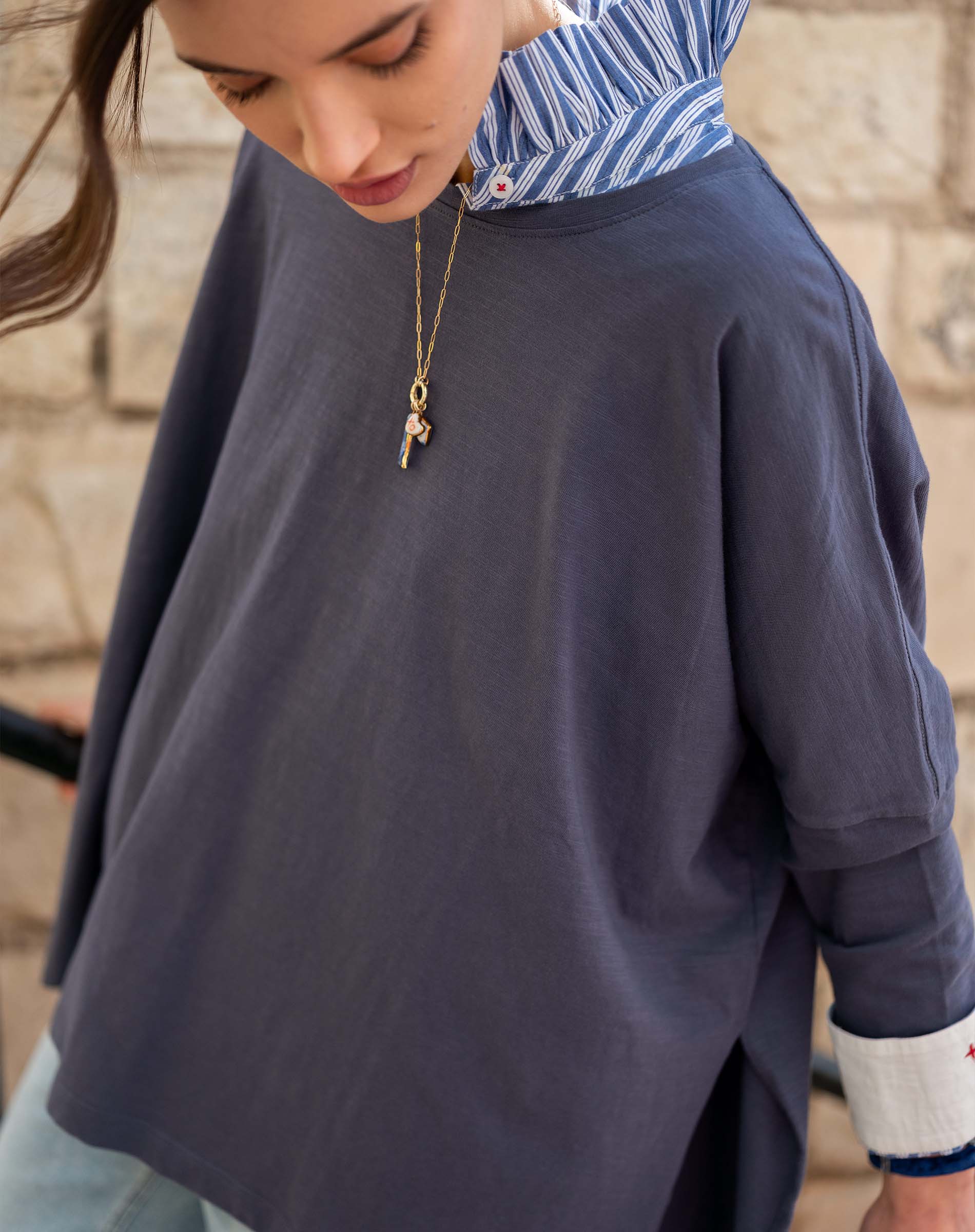 Indigo slub tee with a striped inner collar and cuff detail.