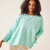Woman wearing a light blue sweater against a plain background
