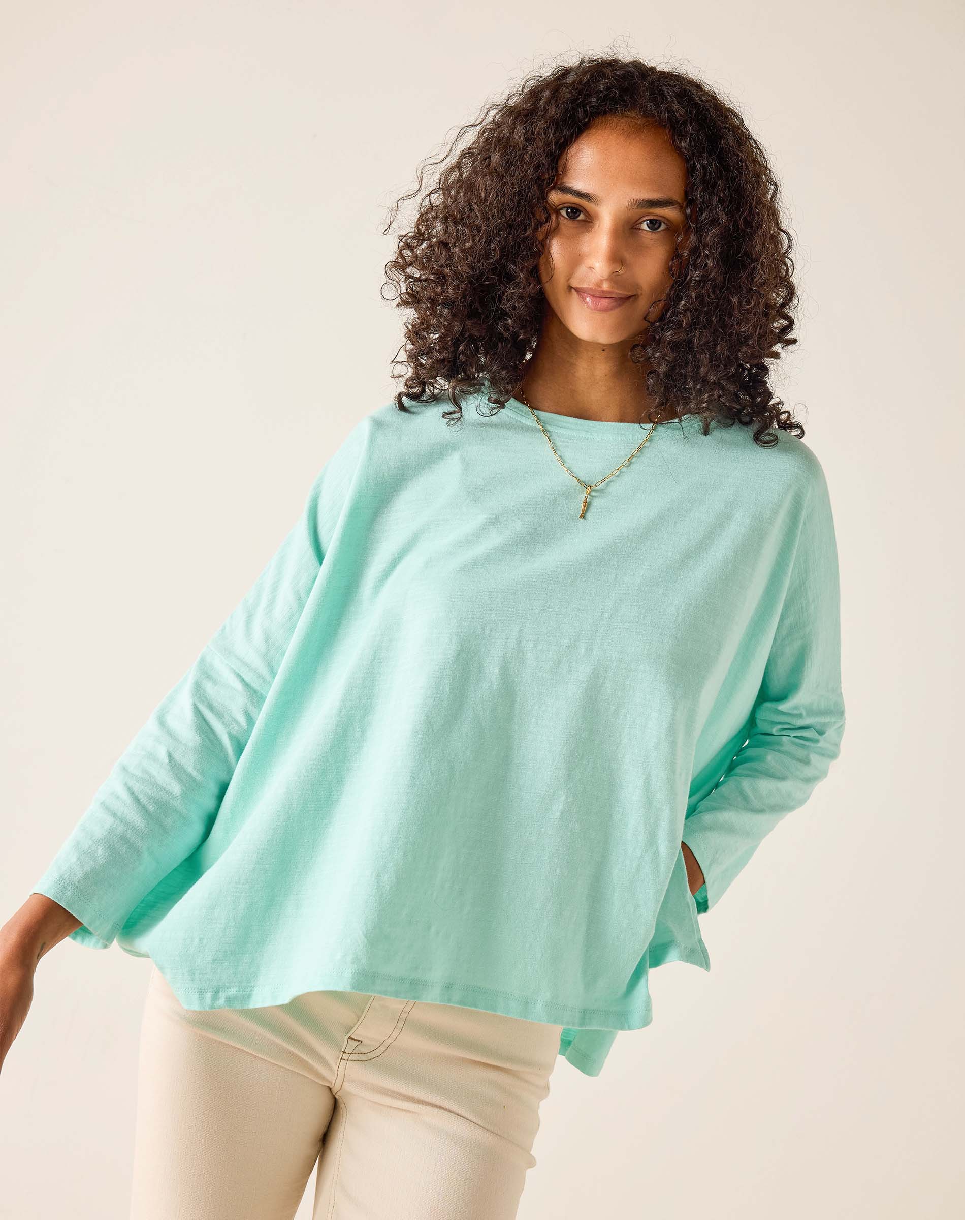 Woman wearing a light blue sweater against a plain background