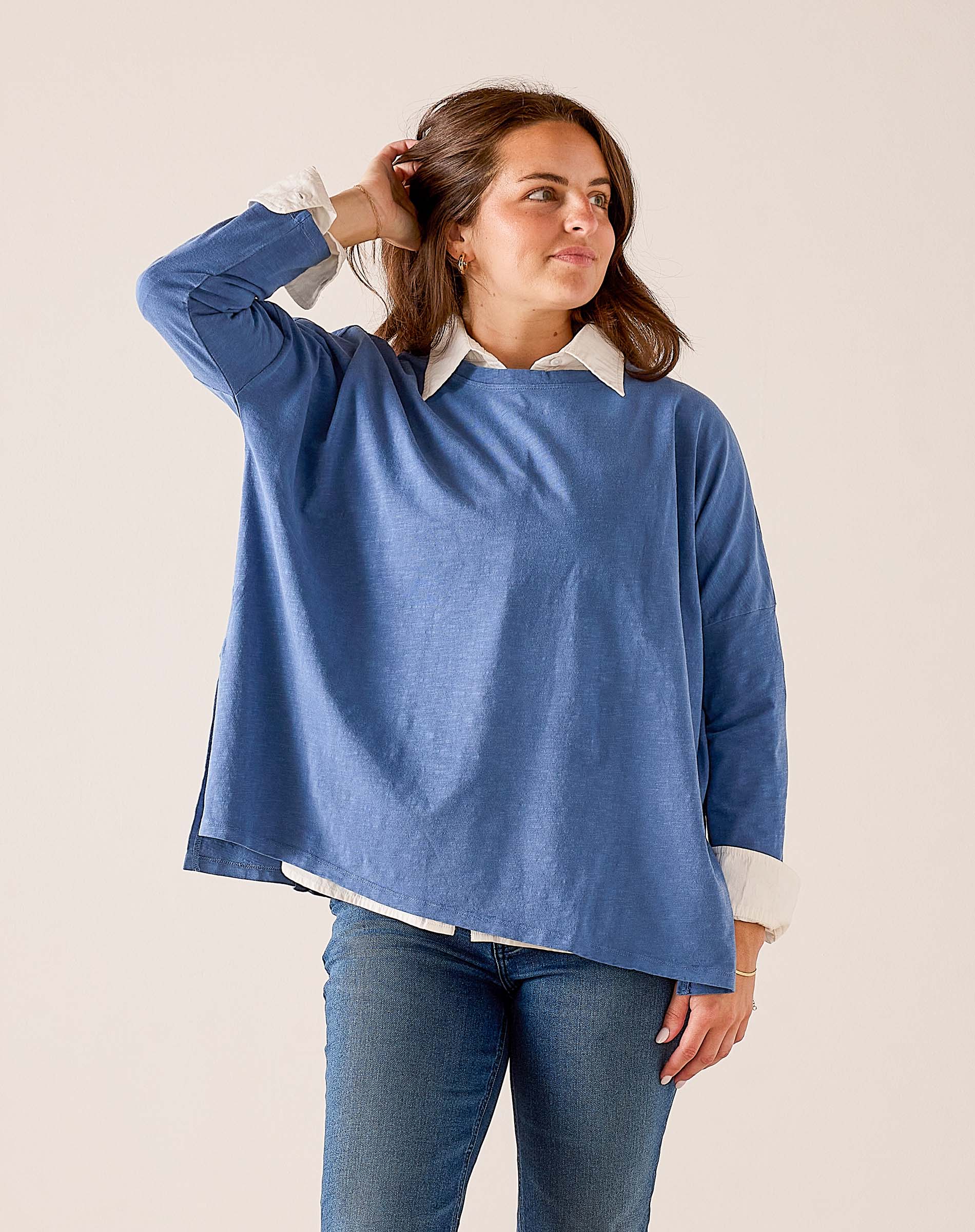 Indigo sunwashed cotton tee with a relaxed fit and wide neckline layered over a white collared shirt.