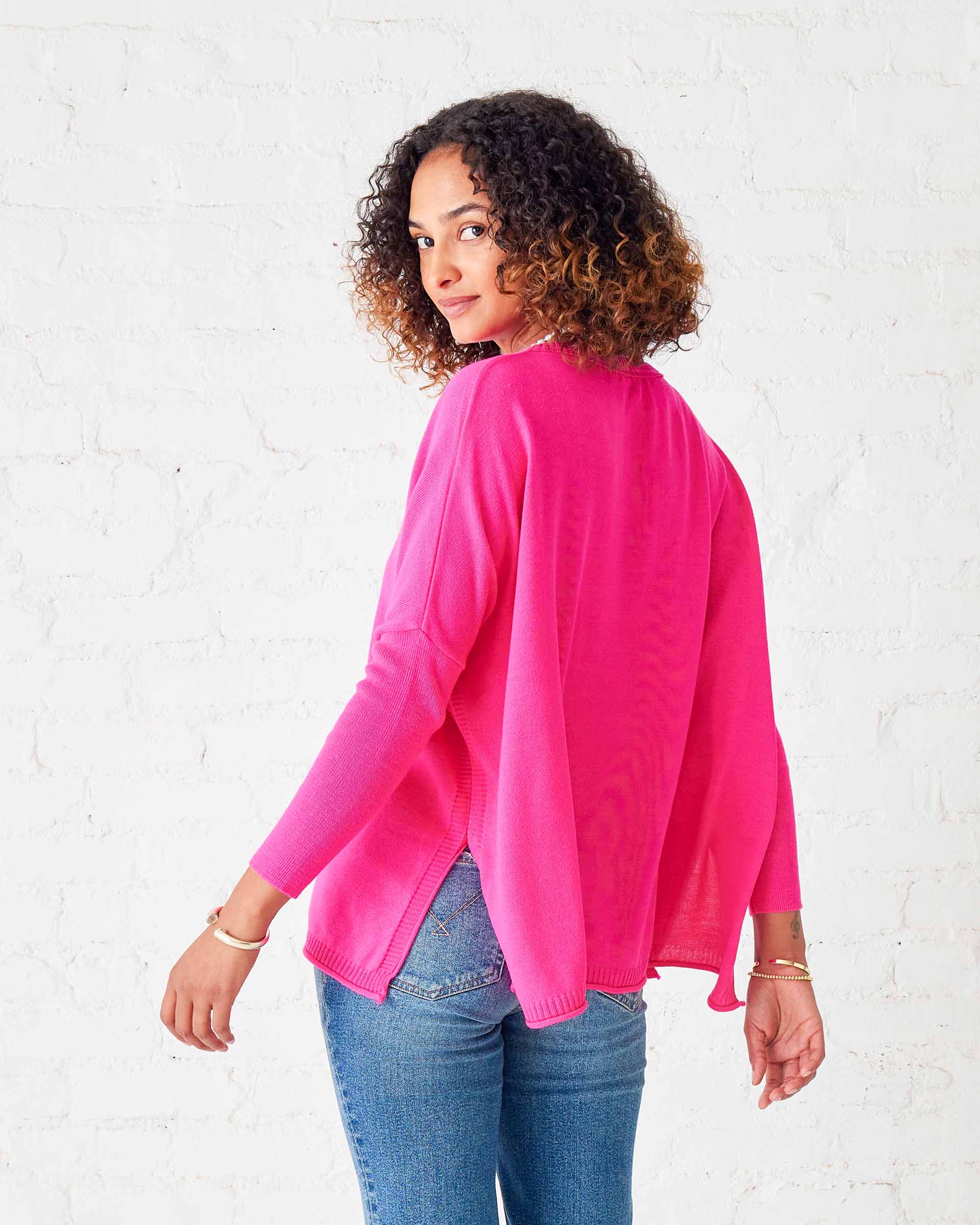 woman wearing lipstick colored Catalina oversized crewneck sweater with split sides and pocket details