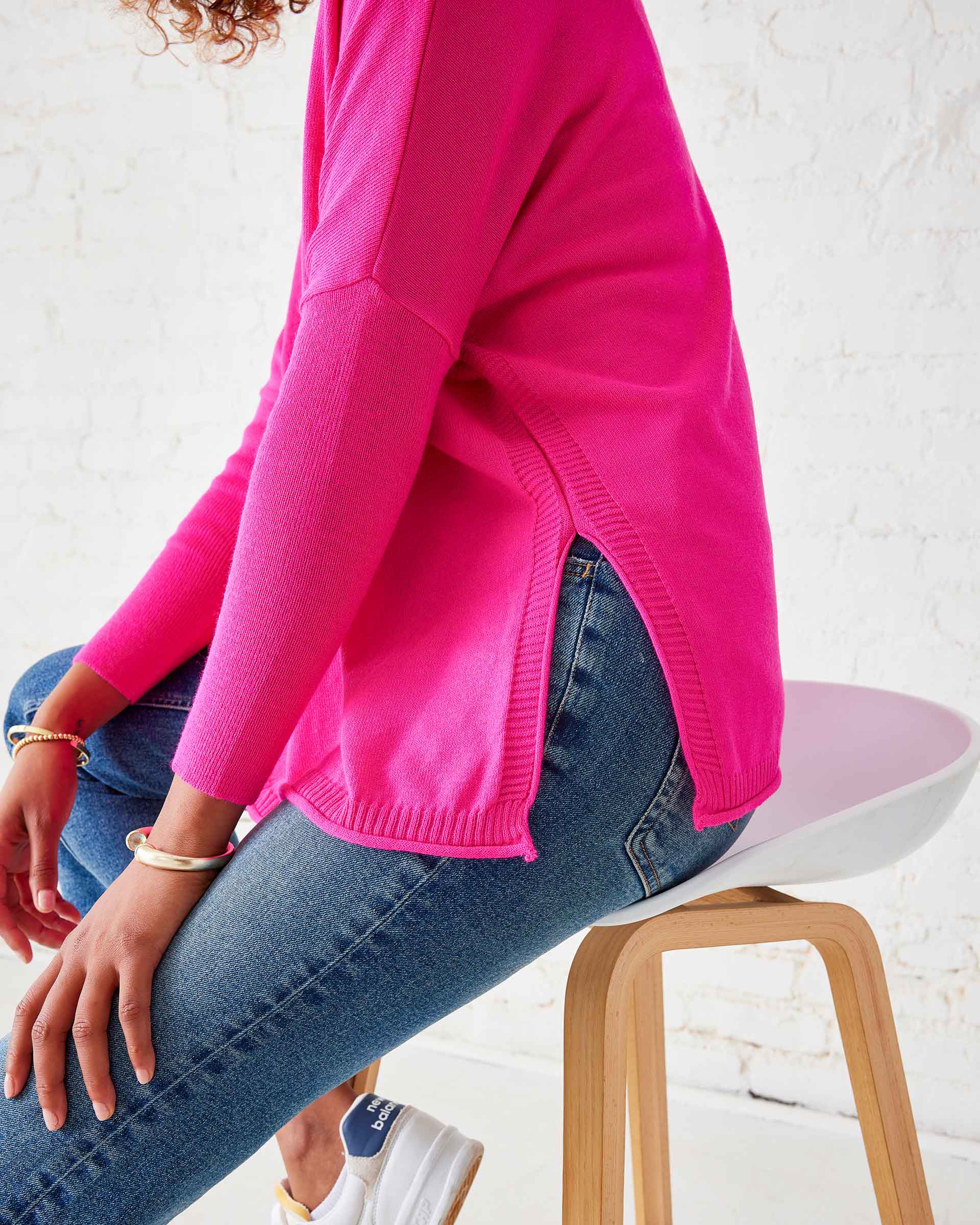rear view of woman wearing lipstick colored Catalina oversized crewneck sweater with split sides and pocket details