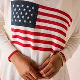 Person wearing a sweater with an American flag design.
