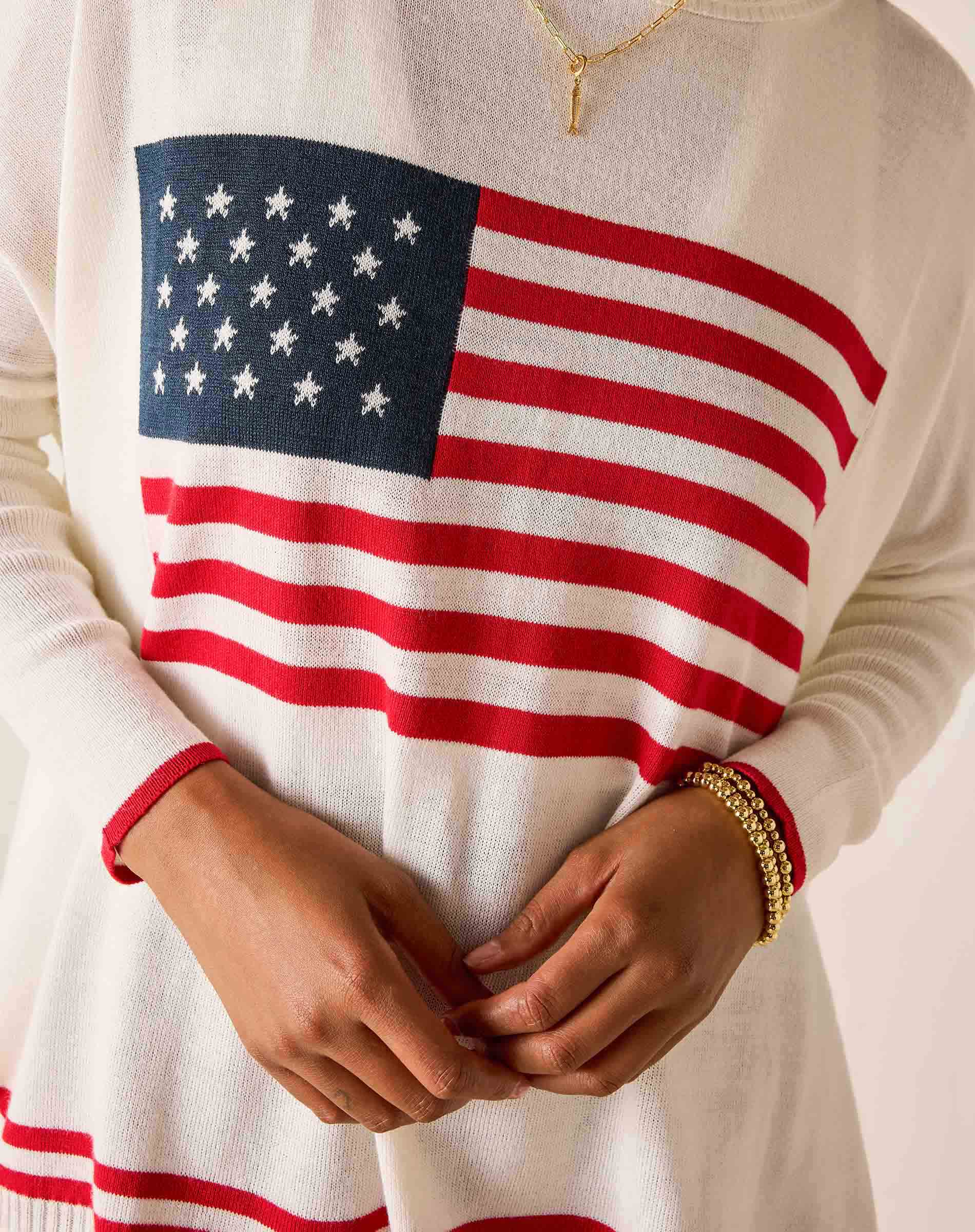 Person wearing a sweater with an American flag design.