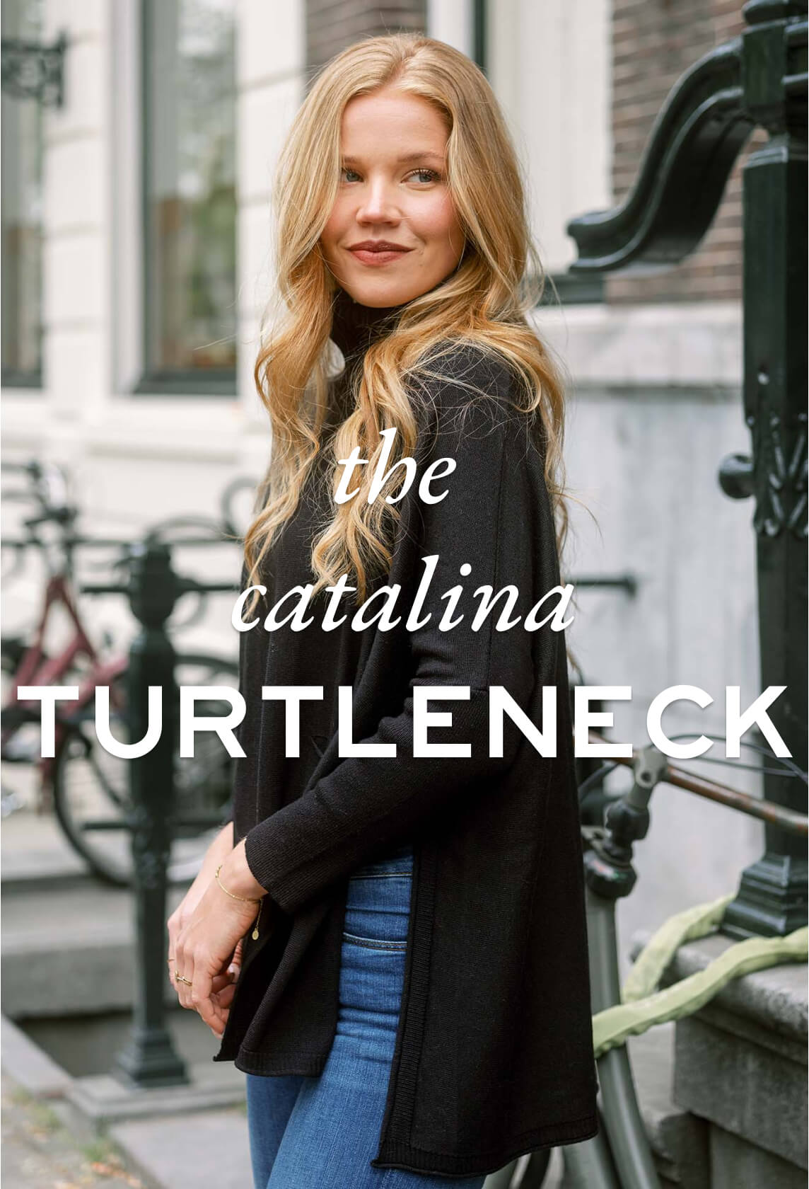 the catalina turtleneck - women wearing black turtleneck sweater with split sides on a street sidewalk