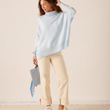 Ladies' travel-ready sky blue ribbed knit turtleneck sweater.