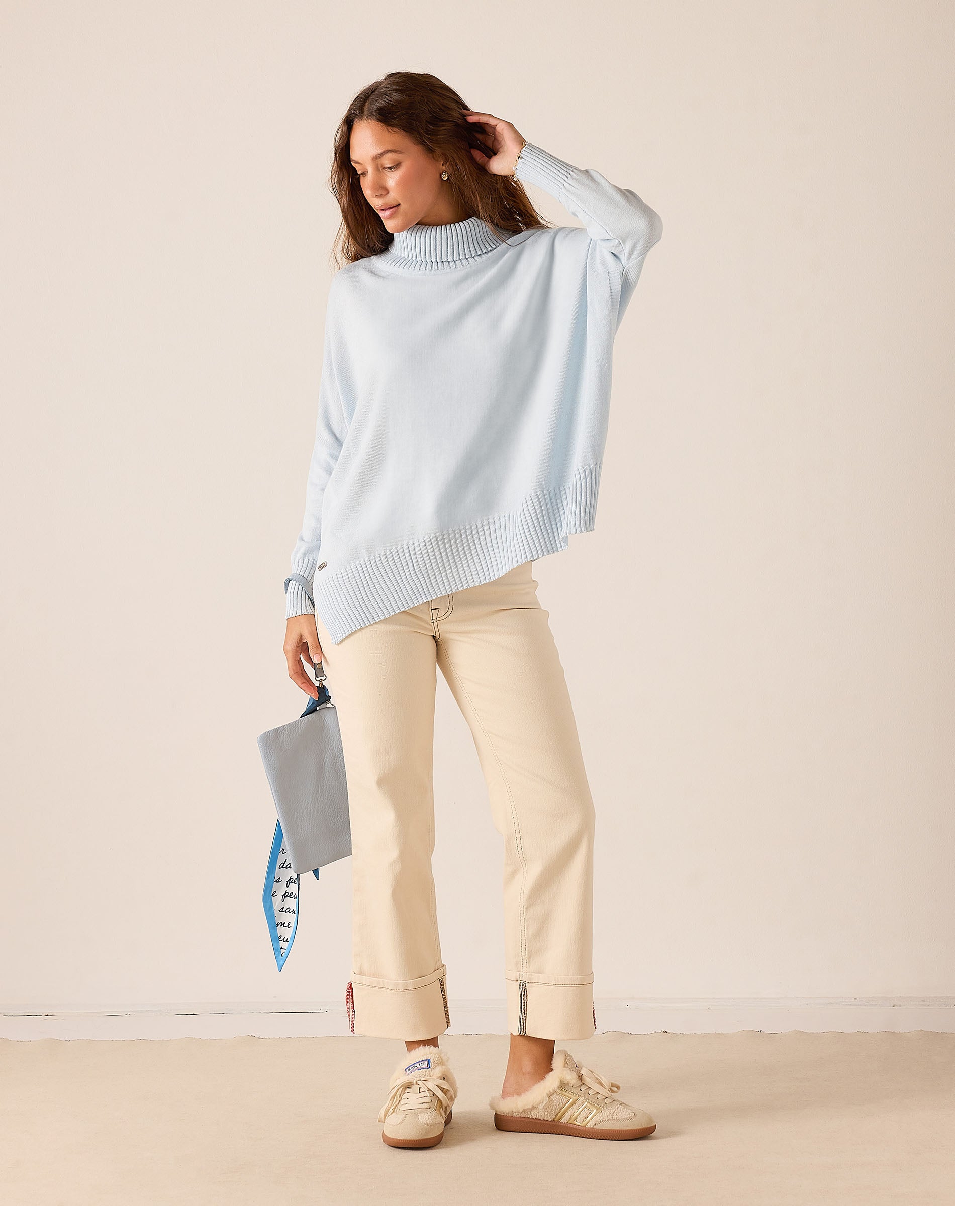 Ladies' travel-ready sky blue ribbed knit turtleneck sweater.