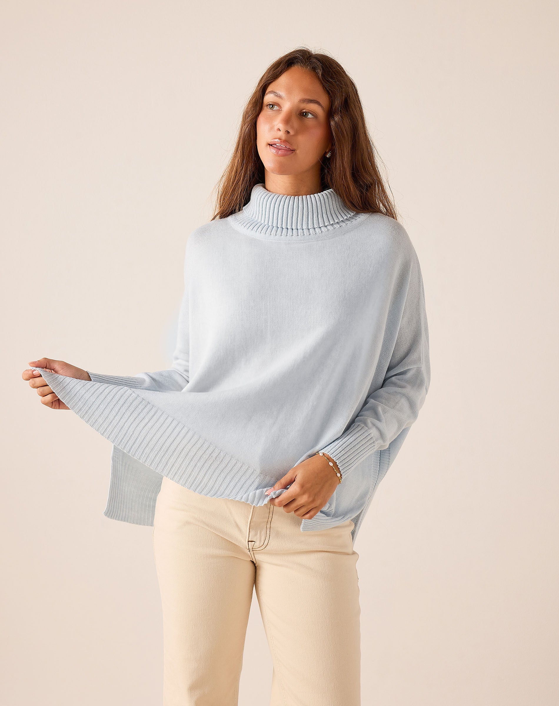 Sky blue oversized turtleneck knit sweater with ribbed cuffs and hem.