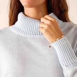 Sky blue ribbed knit turtleneck sweater with long sleeves.