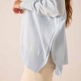 Sky blue oversized ribbed turtleneck sweater with a side slit and wide ribbed hem.