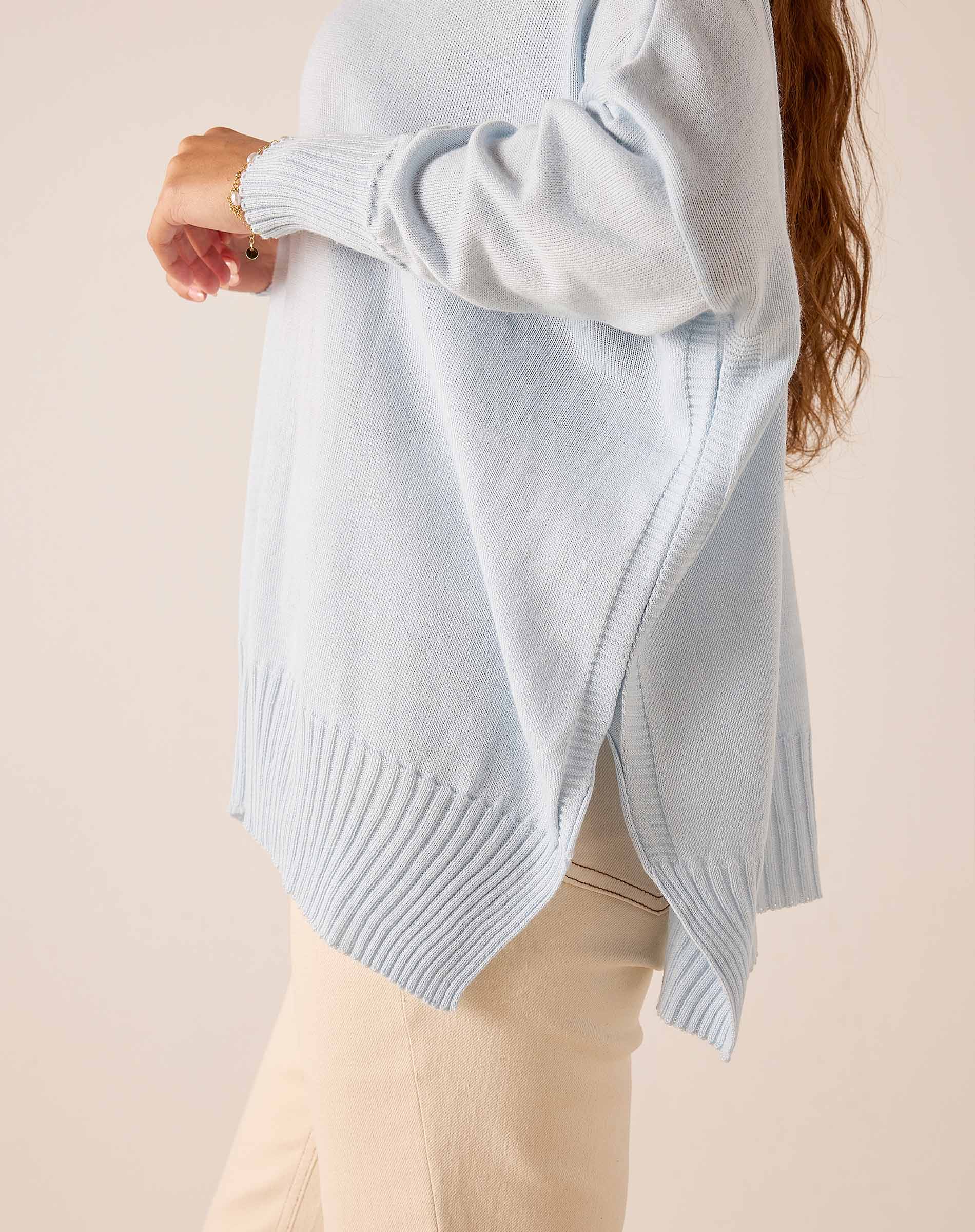 Sky blue oversized ribbed turtleneck sweater with a side slit and wide ribbed hem.