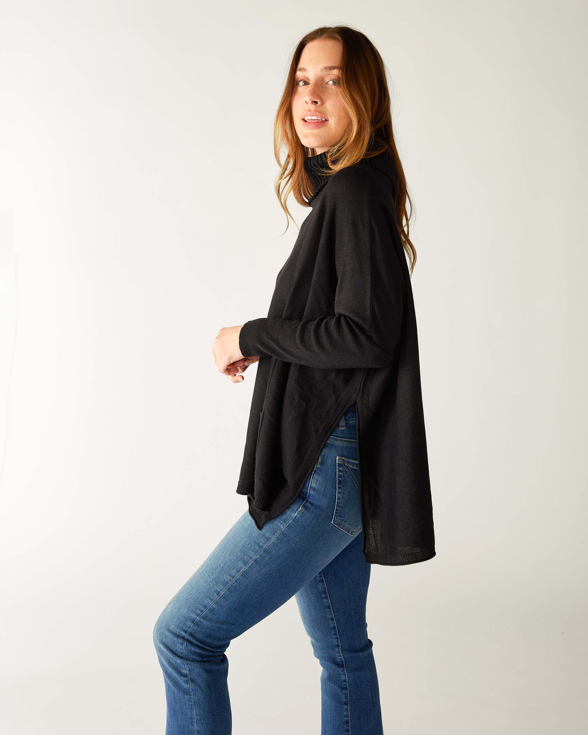 profile of woman wearing lightweight knit mersea catalina turtleneck sweater in black