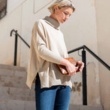 Putty ribbed knit turtleneck sweater with dropped shoulders and long sleeves.