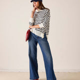 Ladies' travel-ready white and navy striped turtleneck sweater in a ribbed knit.