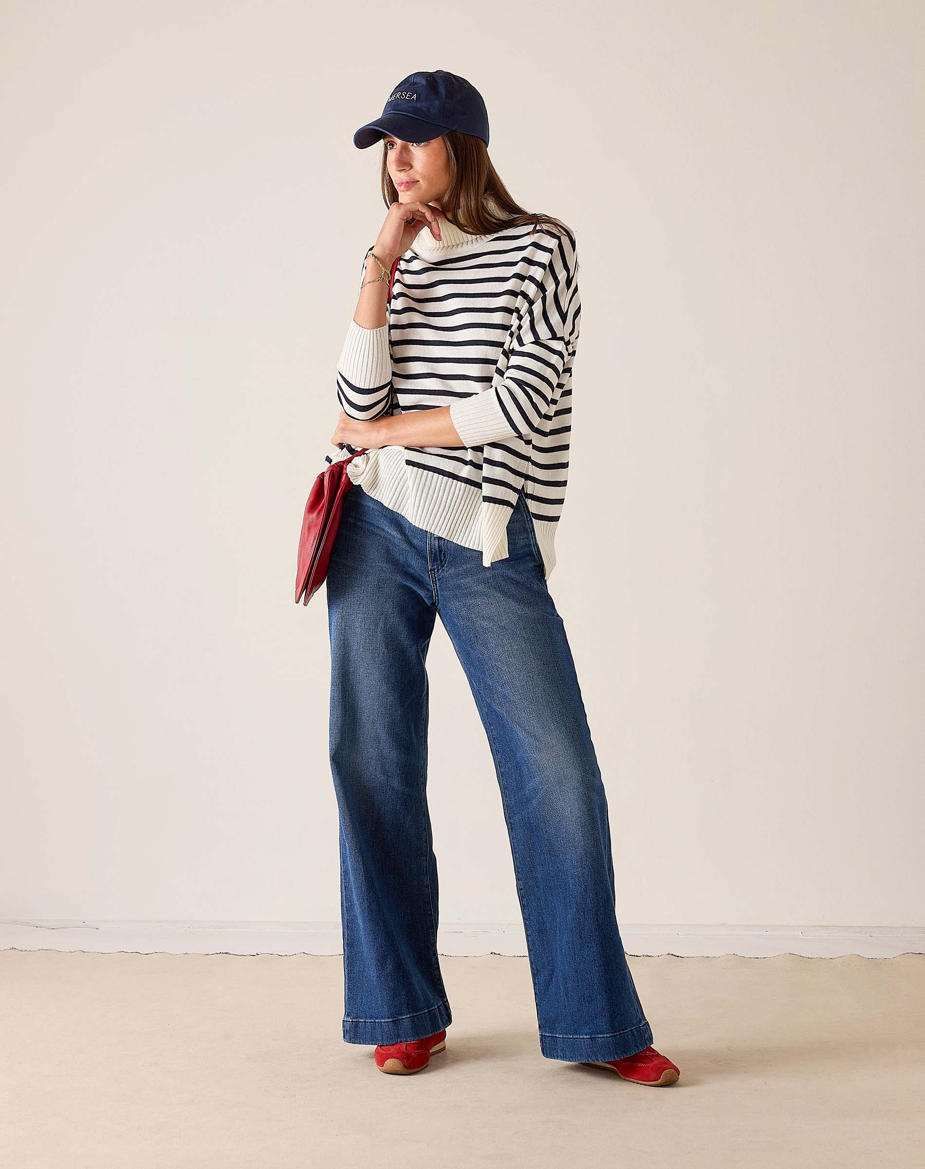 Ladies' travel-ready white and navy striped turtleneck sweater in a ribbed knit.