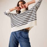White and navy striped knit turtleneck sweater with a relaxed fit and ribbed trim.