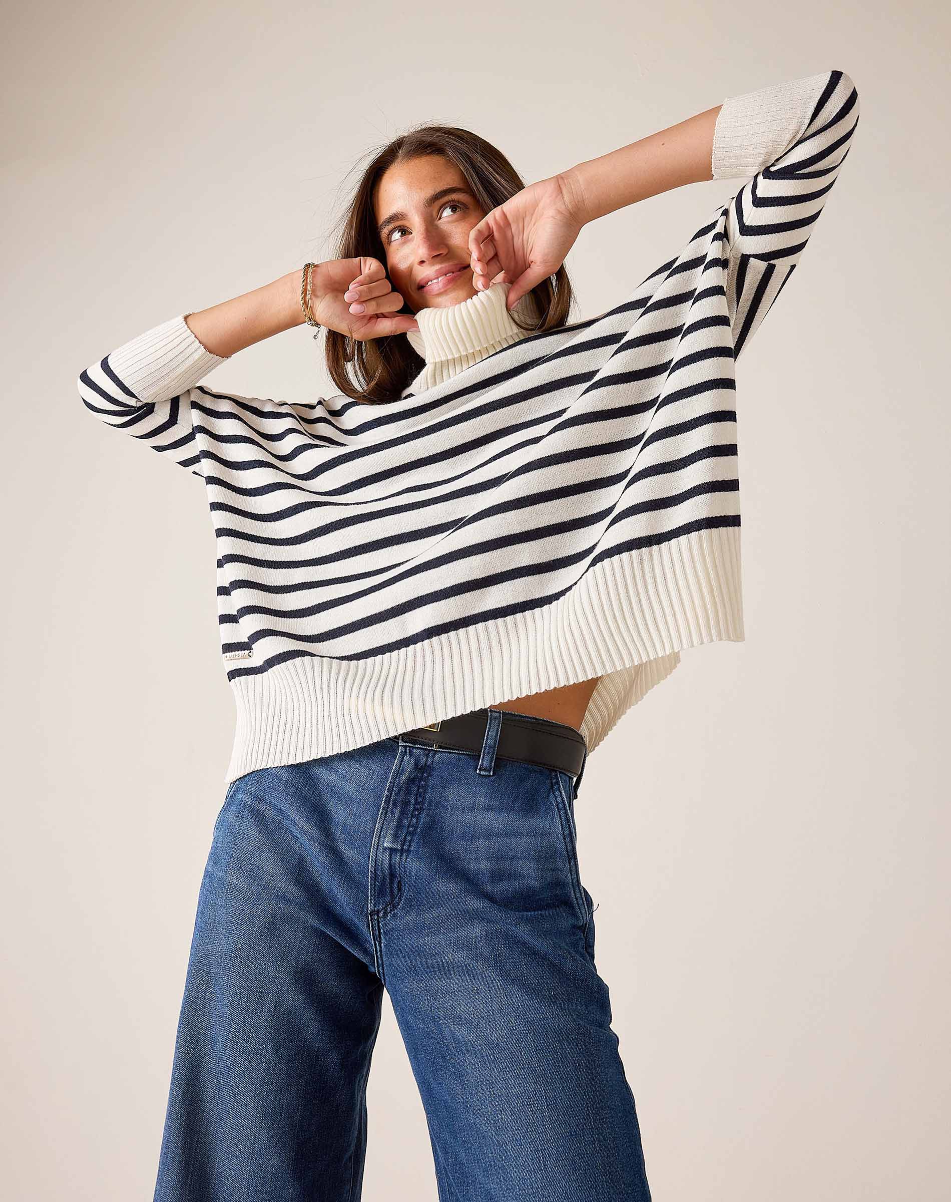 White and navy striped knit turtleneck sweater with a relaxed fit and ribbed trim.