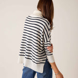 White and navy striped turtleneck sweater with a relaxed fit and ribbed knit texture