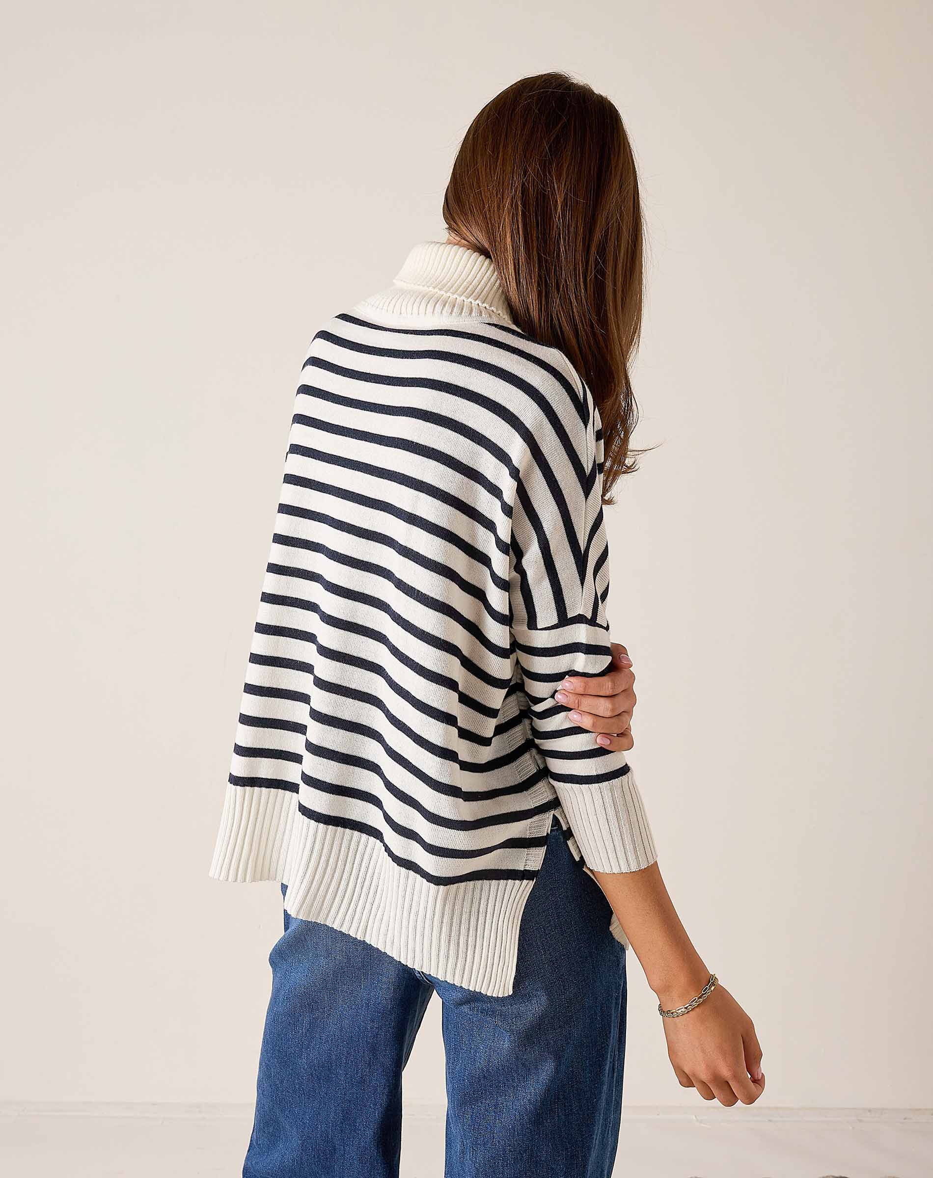 White and navy striped turtleneck sweater with a relaxed fit and ribbed knit texture