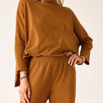Person wearing a brown outfit on a white background