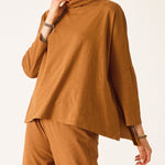 Person wearing a brown outfit on a white background