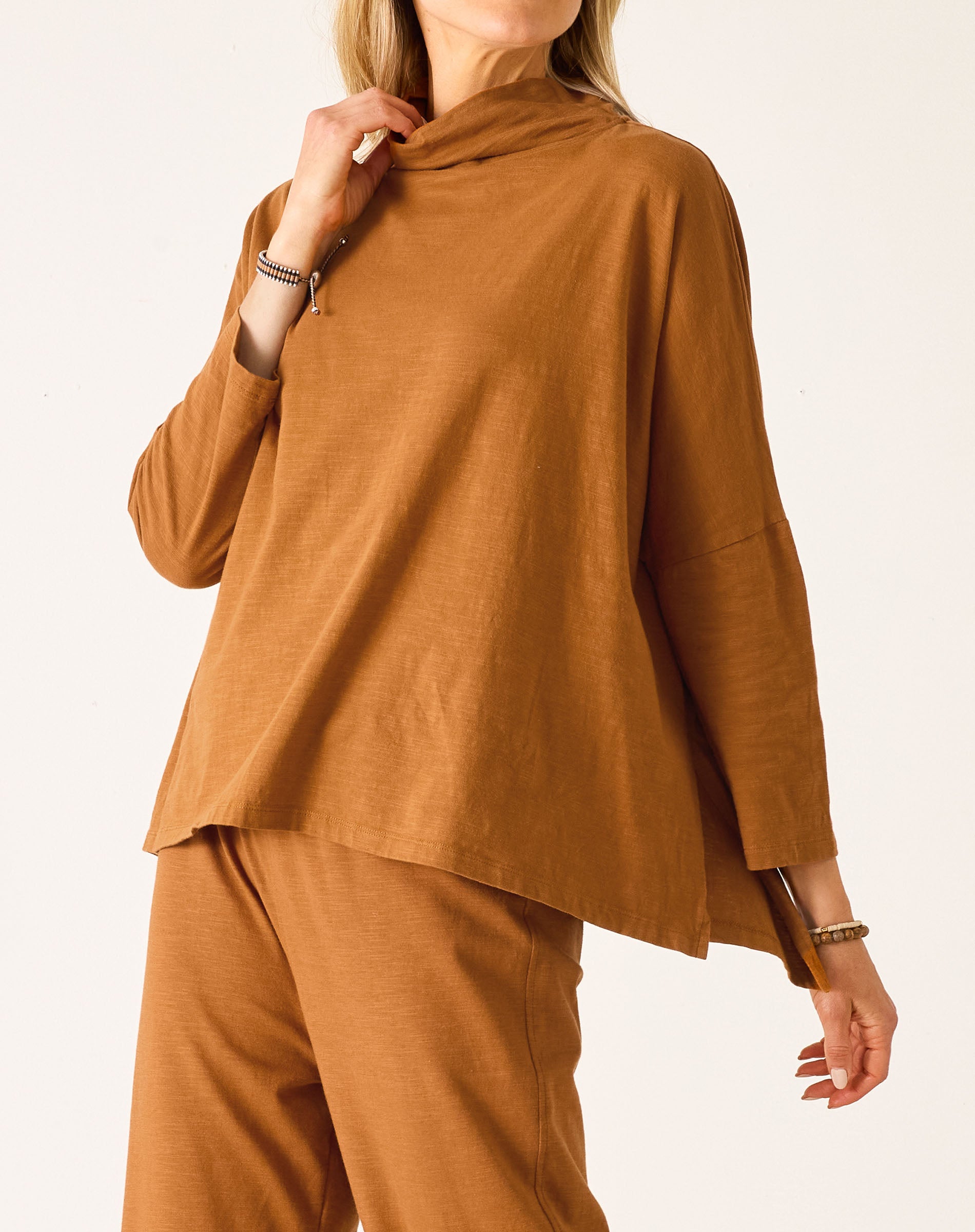 Person wearing a brown outfit on a white background