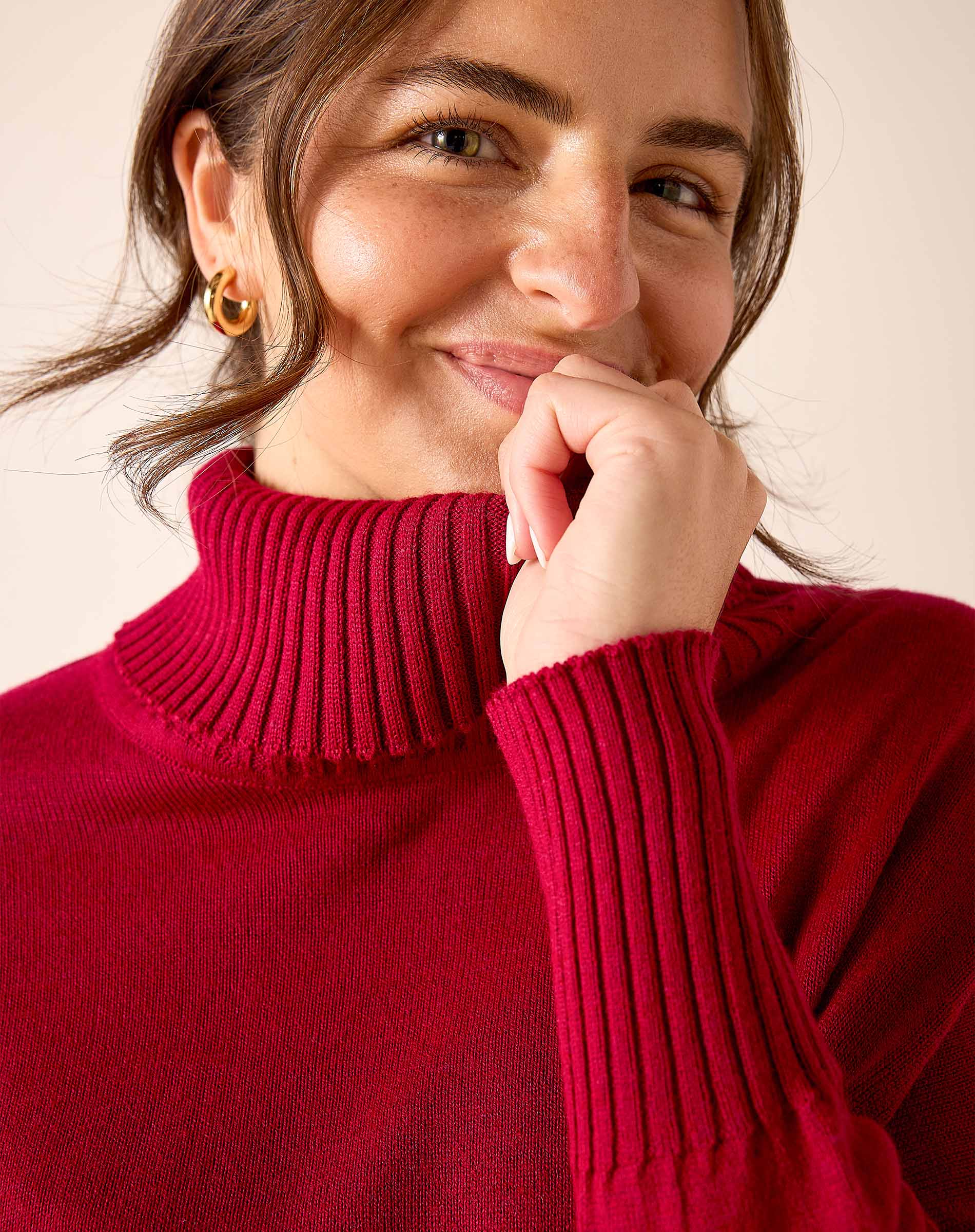 Wine red ribbed knit turtleneck sweater with long sleeves.
