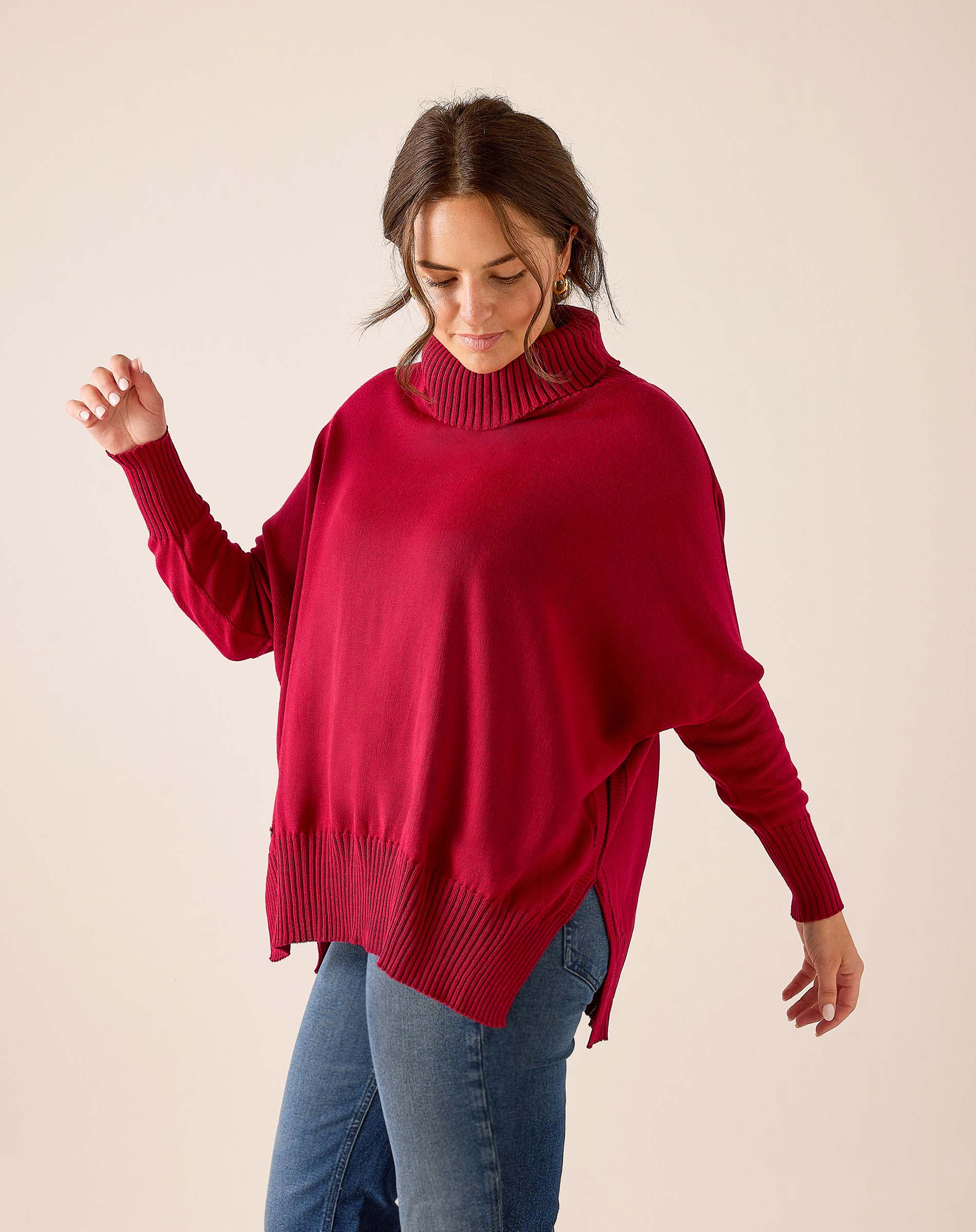 Wine red ribbed knit turtleneck sweater with a loose fit and dropped shoulders.