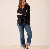 Women's travel-friendly black v-neck knit sweater with a relaxed fit and draped silhouette.