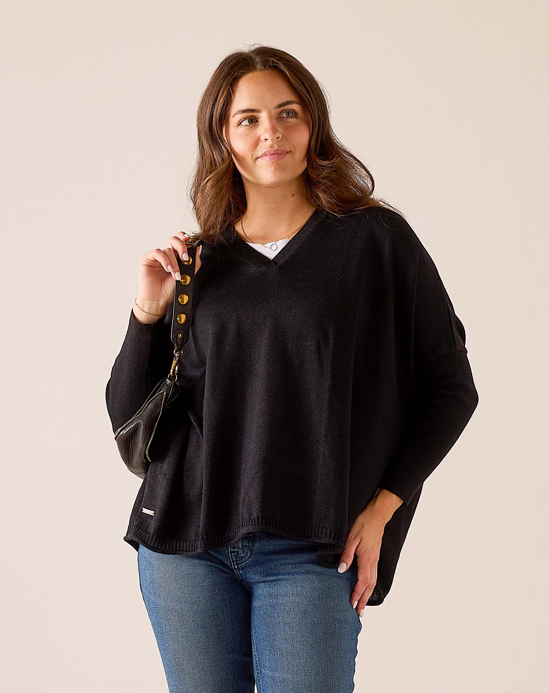 Black V-neck knit sweater with a relaxed fit.
