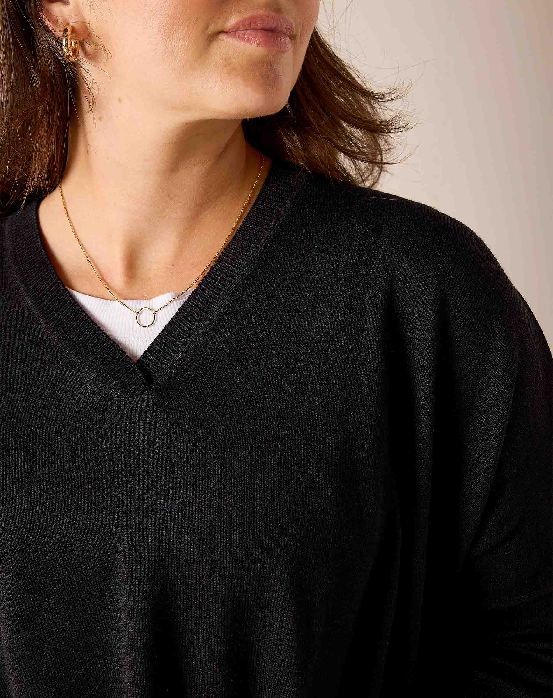 Black knit v-neck sweater with ribbed trim.
