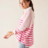 Woman wearing a pink and white striped shirt against a plain background