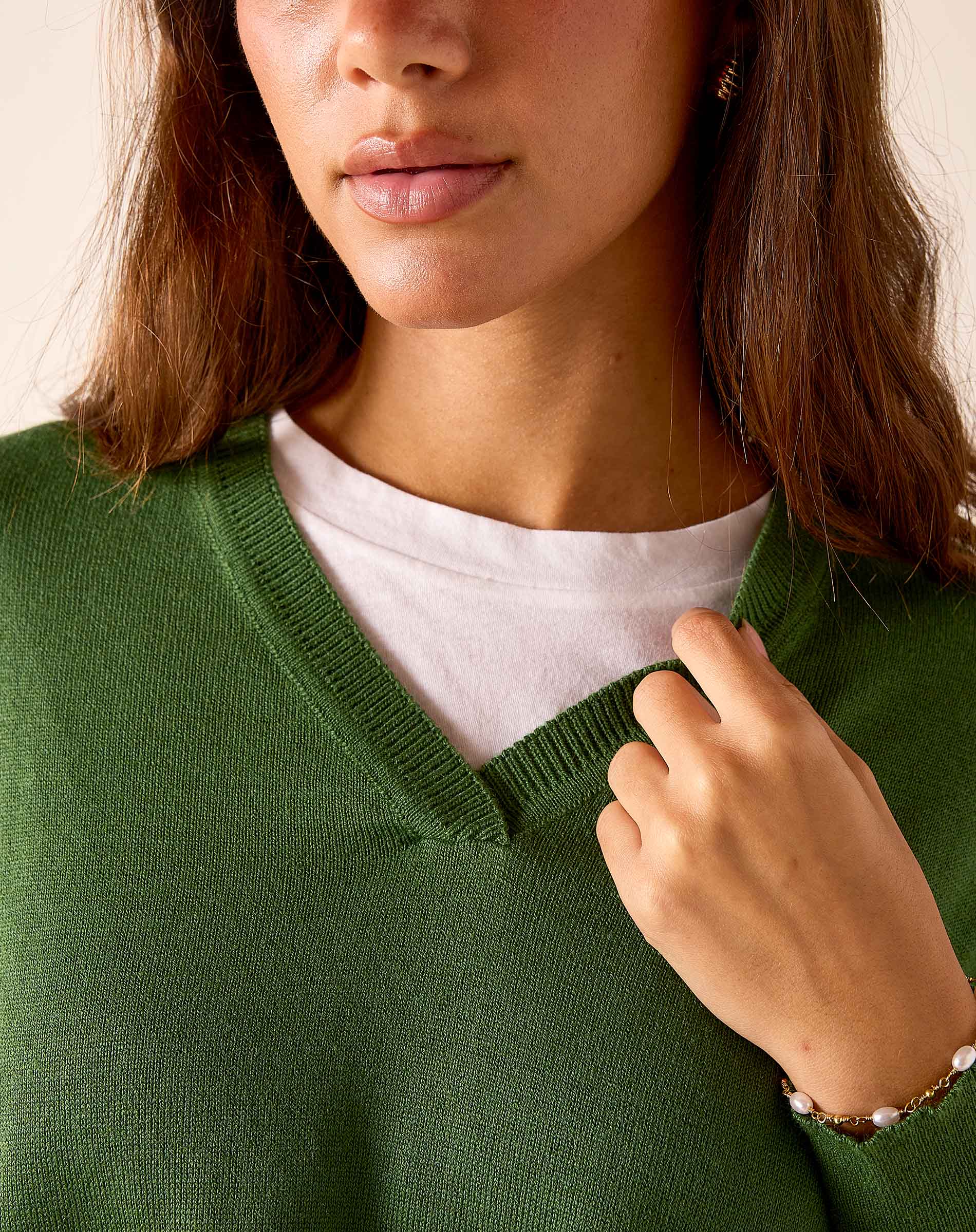 Ladies' travel-ready emerald green ribbed knit v-neck sweater.