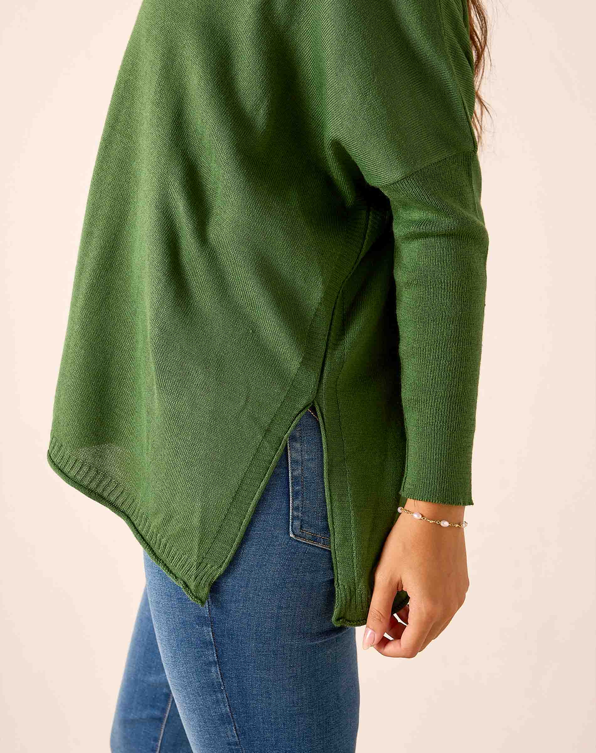Emerald green ribbed knit v-neck sweater with a relaxed fit and draped front hem.