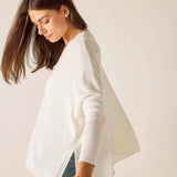 Woman wearing a white blouse with a plain background