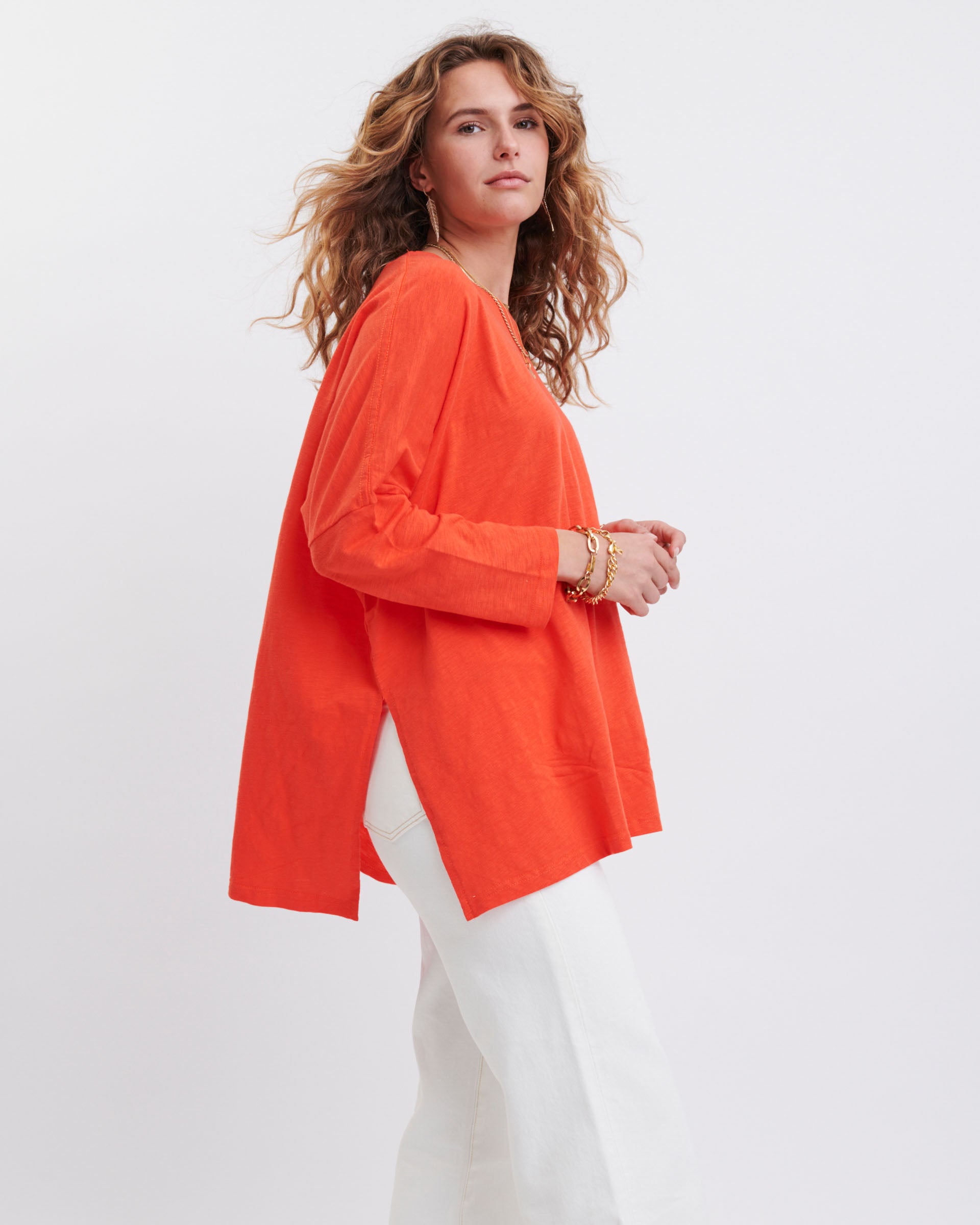 profile of woman wearing bright orange oversized mersea catalina slub tee