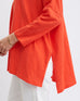 closeup of side of woman wearing bright orange oversized mersea catalina slub tee