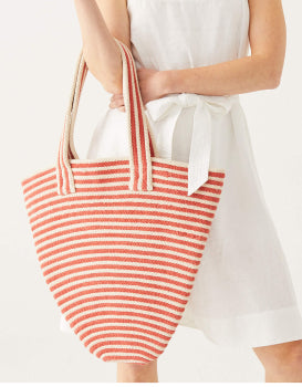 female holding red and white striped tote bag on a white background