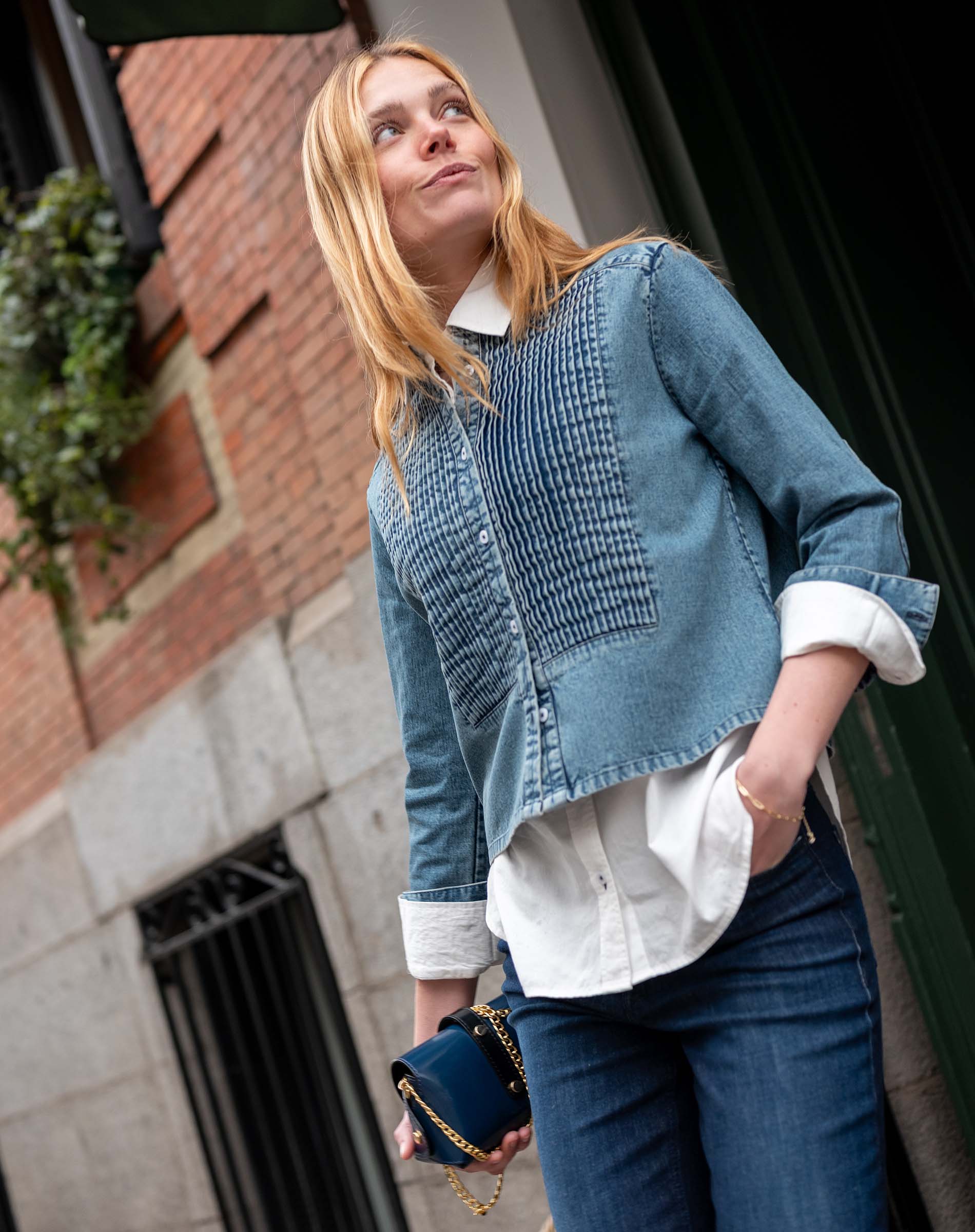 Stonewash blue chambray tuxedo shirt with a unique quilted panel design and rolled sleeves.