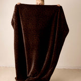 Leopard print faux fur blanket in mocha brown.